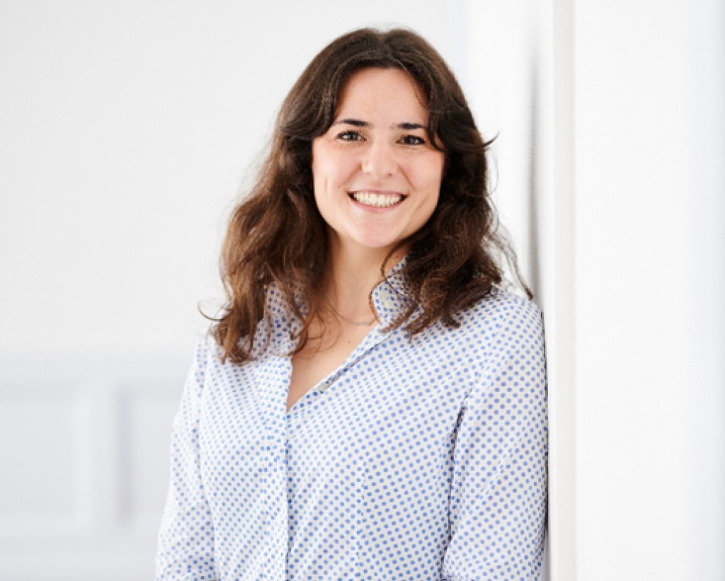 woman with brown hair smiling at camera.